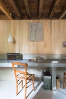 Concrete desk with wooden chair 