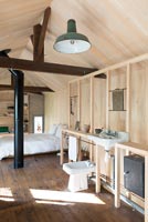 Timber frame bathroom in open plan bedroom 