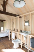 Timber frame bathroom in open plan bedroom 