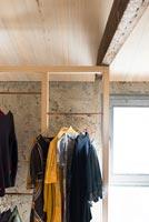 Open timber frame wardrobe and exposed wooden beams 