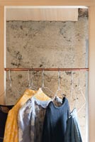 Clothes hanging in modern wardrobe