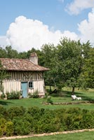 Country cottage exterior with sheep sculptures