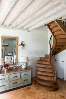 Wooden spiral staircase in country house