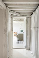 White painted hallway in country hallway with view to bedroom 