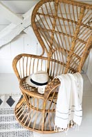 Wicker chair with hat and scarf