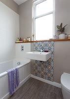 Patterned tile splashback in modern bathroom 