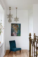 Star shaped pendant lights and chair in bedroom 