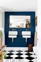 Painted feature wall with twin sinks in classic bathroom 