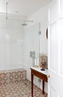 Patterned tile floor in classic bathroom with shower cubicle