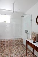 Patterned tile floor in classic bathroom with shower cubicle