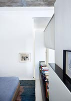 Partition wall with bookshelf in small studio apartment bedroom