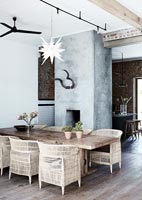 Modern country dining room with concrete fireplace  