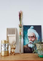 Eclectic collection of objects and a painting on sideboard 
