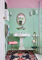 Classic bathroom with green tiled wall and period details 