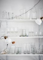 White shelving unit filled with glassware