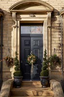 Exterior of large country house front door with Christmas wreath 