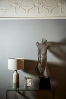 Sculpture on side table with lamp 