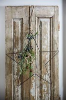 Star shaped Christmas decorations on old wooden door 