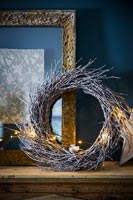 Wreath of branches on mantelpiece