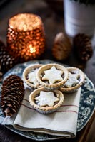 Mince pies on plate with candle 