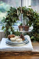 Mince pies on plate in front of wreath 