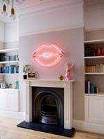 Pink neon lips - artwork above fireplace 
