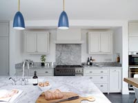 Modern kitchen with marble worktop and splashback