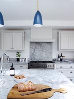 Modern kitchen with marble worktop and splashback 