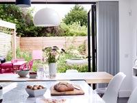 Patio doors in modern kitchen open to garden 