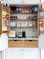 Coffee maker and toaster in modern kitchen cabinet 