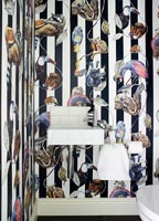 Colourful wallpaper on feature wall in modern bathroom 