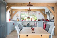 Modern country kitchen with exposed wooden beams and dining table