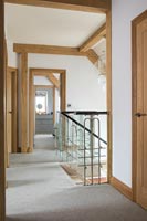 Modern upstairs landing with exposed wooden beams 