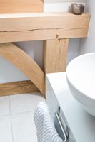 Modern bathroom sink and detail of wooden beams 