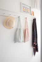 Material bags hanging on hallway hooks 