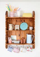 Pine shelf with cup hooks and collectibles 