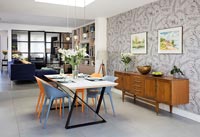 Modern dining room with feature wall and vintage sideboard 