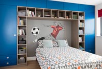 Childrens bedroom with built-in storage and mural on feature wall 