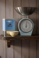 Vintage weighing scales and tin of flour on shelf 