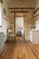 Hallway in country house with exposed wooden beams and stone walls 