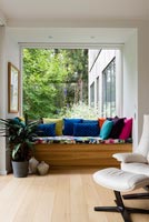 Built in window seat with colourful cushions 