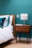 Vintage side table and lamp in bedroom 