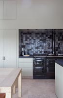 Contemporary kitchen with Aga range and tiled splashbacks 