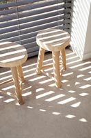 Wooden log stools bathed in sunlight  