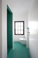 Modern bathroom tiled throughout in aqua green mosaic tiles 