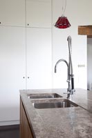 Kitchen sink in modern kitchen with marble worktop