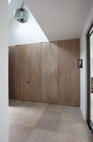 Hallway with large wooden built in cupboards 