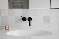 Contemporary bathroom sink with black tap 