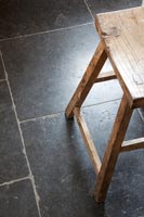 Black floor and wooden stool 