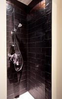 Shower cubicle with dark brick tiles 